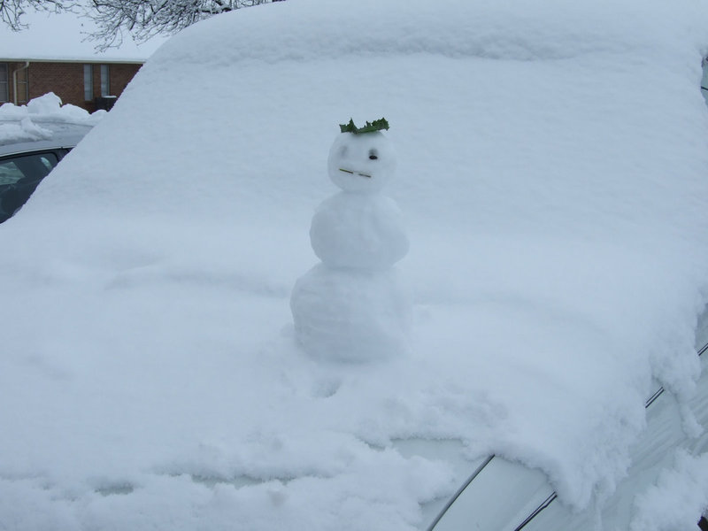 Image: Truck Snowman — This snowman was riding with his owner on the hood of the truck. Amazing balance and strength, don’t you think? It could have been the holly hat.
