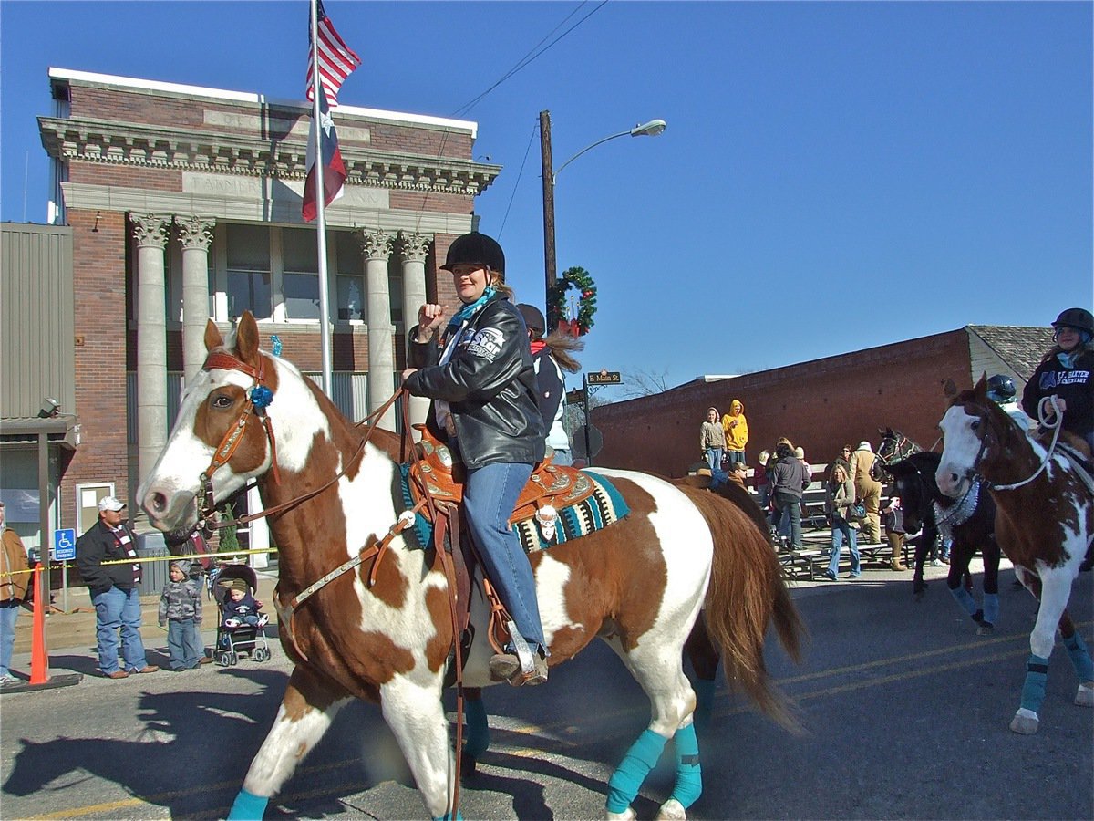 Image: Back in the saddle — Reminiscent of last years parade, beautiful horses lead the parade down Main Street in Italy.