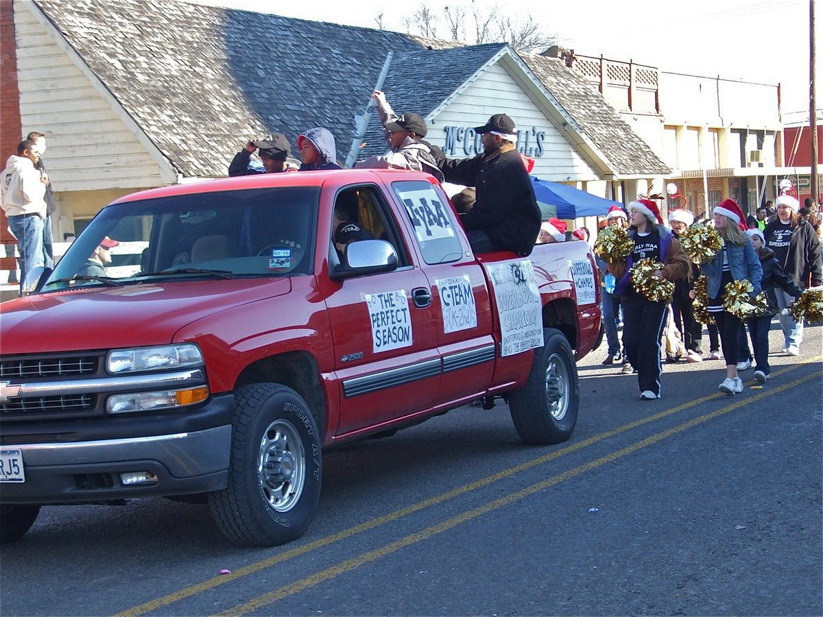Image: Superbowl Champs! — Garret Wood, with a little help from his father Coach Gary Wood, drove the undefeated and unscored-on Superbowl Champions, IYAA C-Team Gladiators, thru downtown Italy during the parade.