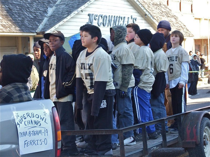 Image: Superbowl Champs! — The IYAA B-Team Gladiators Superbowl Champions stand undefeated as they float thru the parade.
