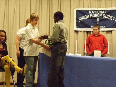 Image: A handshake of welcome — Matthew Levy shakes Deiondre Cochran’s hand as he receives his service pin.