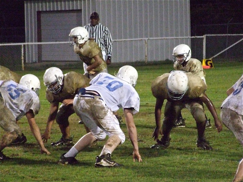 Image: Staying low — Italy’s offensive line tries to stay low against the Bulldogs.