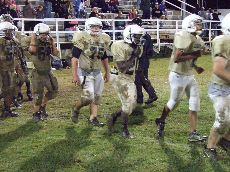 Image: Good sports — The game was a little muddy and the score was lopsided but at least the team had some fun in the mud.