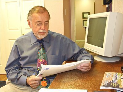 Image: Dr. George Telatnyk — Affectionately known as “Dr. T” around the Italy Dental office, Dr. Telatnyk looks over a patients chart.