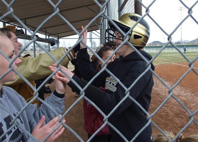 Image: Nice hit! Good Job! — Teammates congratulate Courtney Westbrook on getting a hit and scoring against the Lady Lions.