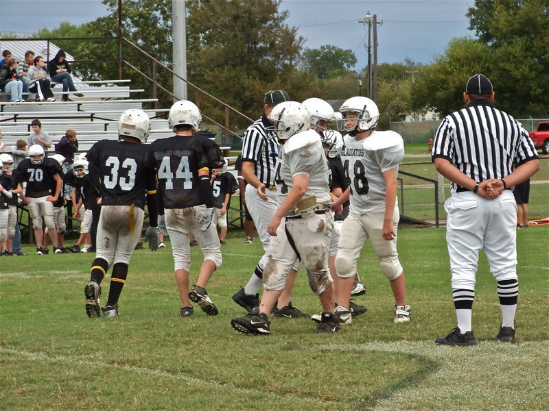 Image: Captain’s shake hands — Game captain’s John Byers(54) and Bailey Walton(48) tell the Bulldog captains, “good luck.”