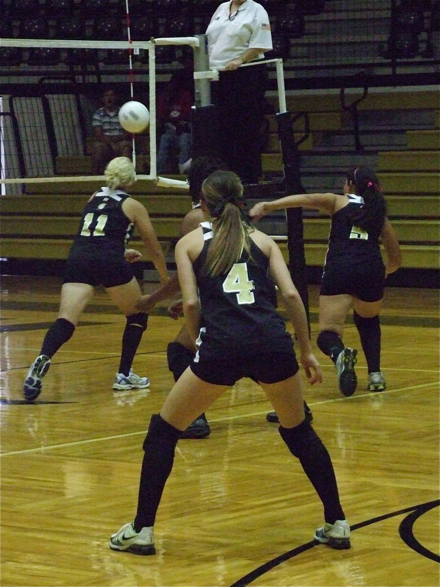 Image: Get it! Get it! — Megan Richards (11) and her sister Alyssa Richards (5) try to keep their chances alive against Milford as Drew Windham (4) and Shay Fleming stay ready.
