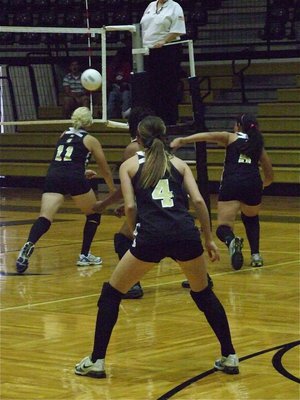 Image: Get it! Get it! — Megan Richards (11) and her sister Alyssa Richards (5) try to keep their chances alive against Milford as Drew Windham (4) and Shay Fleming stay ready.