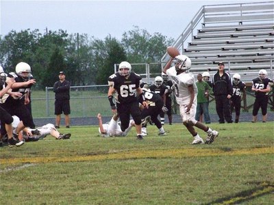 Image: Touch and go — Eric Carson puts touch on the ball as he completes a pass to Trevon Robertson early in the first half.