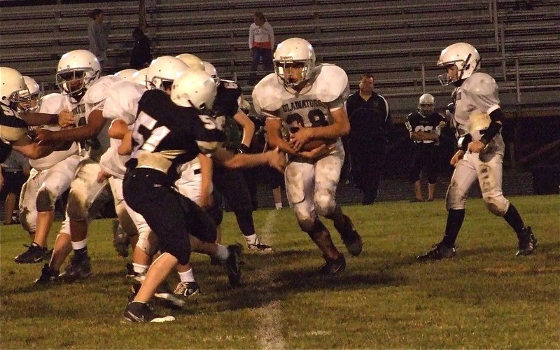Image: Cut man — Kyle Fortenberry kicks out the Hubbard defensive end as Cody Medrano(28) cuts off his block.