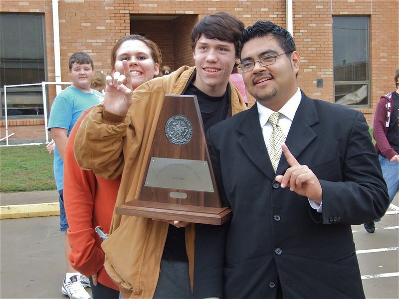 Image: What a day! — Mr. Jesus Perez, poses with band and flag corp members after receiving a police escort back to campus.