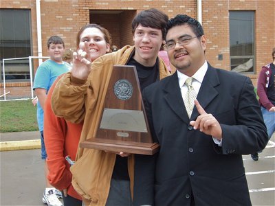 Image: What a day! — Mr. Jesus Perez, poses with band and flag corp members after receiving a police escort back to campus.