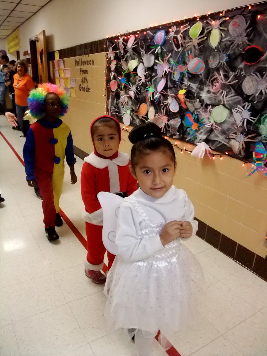 Image: Here Comes the Parade — We have an angel, Santa’s helper and a really cute clown heading the parade.