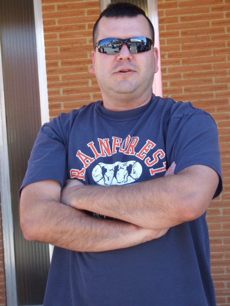Image: The Oklahoma Kid — Eric Peters takes a moment to watch the Homecoming Parade pass through downtown Italy. Eric noticed the walk from one end of town to the other end took about 15-minutes, that’s a quarter of the time he remembered it taking when he was a youth.
