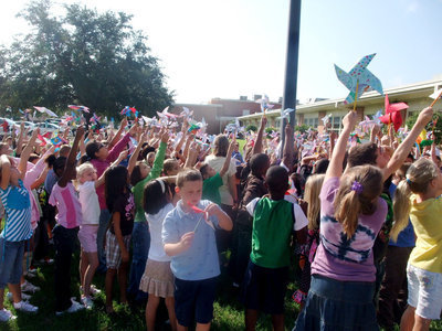 Image: Can I fix it? — This little boy is trying to fix his pinwheel.