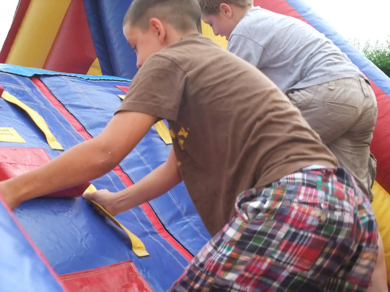 Image: Brothers race — Brothers Gary and J.T. Escamilla try to reach the slide first.