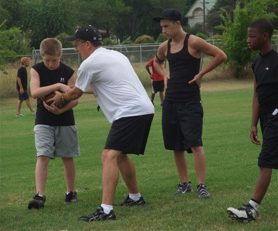 Image: Coach Holley hands off