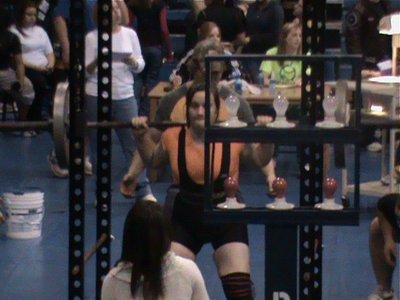 Image: Squat time — Kaytlyn Bales gets comfortable under the bar in the squat cage during the Rice powerlifting meet.
