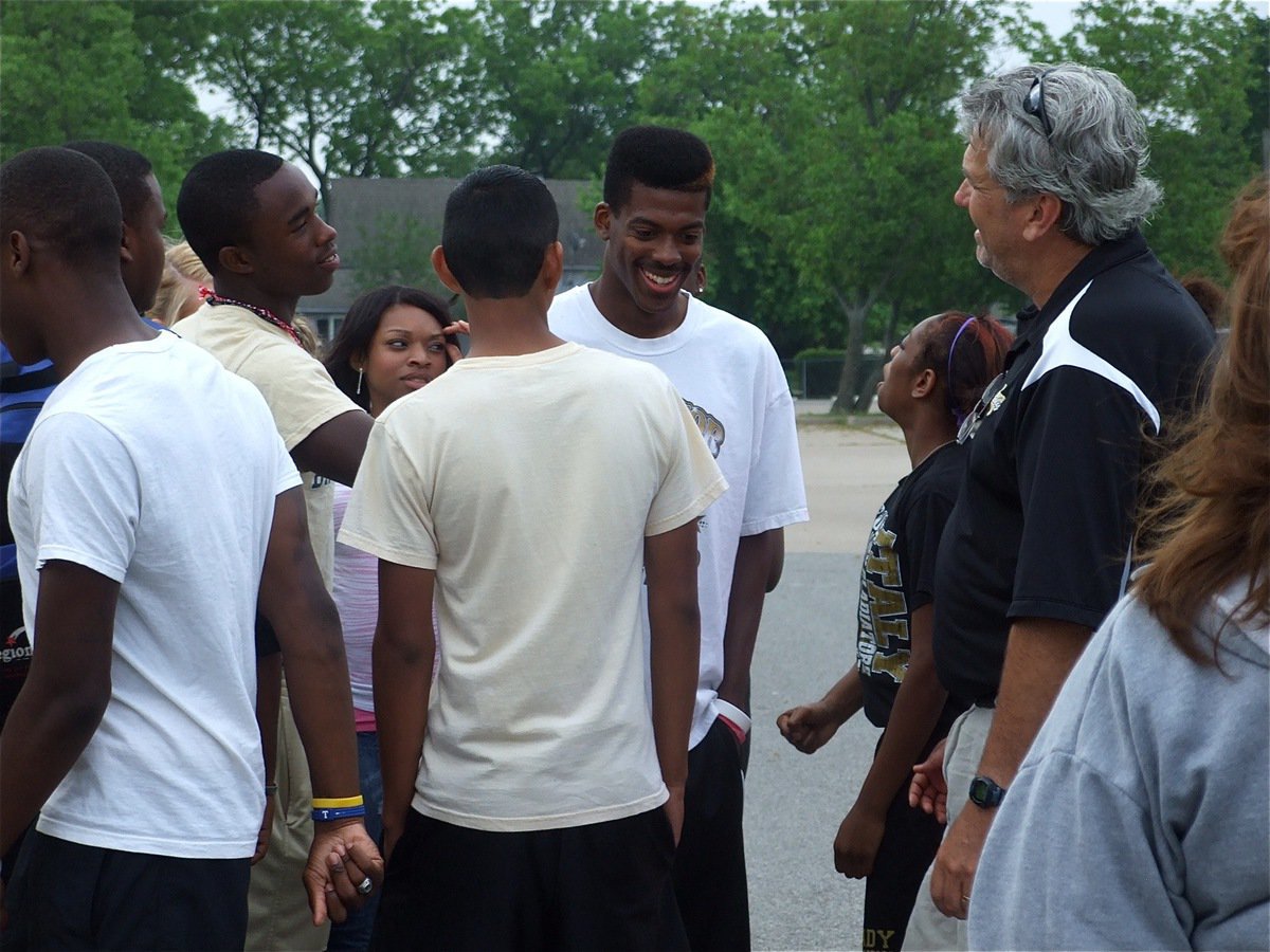 Image: Smiles before the miles — Track teammates Desmond Anderson, Bobby Wilson, Jasenio Anderson, Kyonne Birdsong, Eddie Garcia and Jameka Copeland wish John Isaac and Italy’s head track coach Stephen Coleman good luck before John makes his rock star-like exit and climbs into the Italy ISD van headed for Austin.