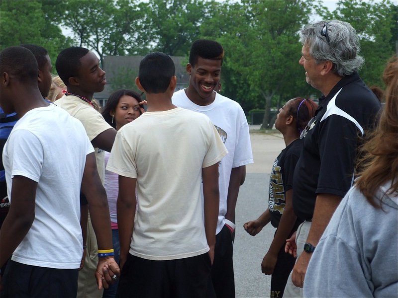 Image: Smiles before the miles — Track teammates Desmond Anderson, Bobby Wilson, Jasenio Anderson, Kyonne Birdsong, Eddie Garcia and Jameka Copeland wish John Isaac and Italy’s head track coach Stephen Coleman good luck before John makes his rock star-like exit and climbs into the Italy ISD van headed for Austin.