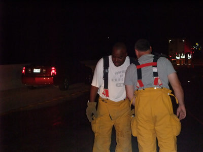 Image: Teammates — Calling a play, just like when they were Gladiators huddling at Willis Field over 20 years ago,