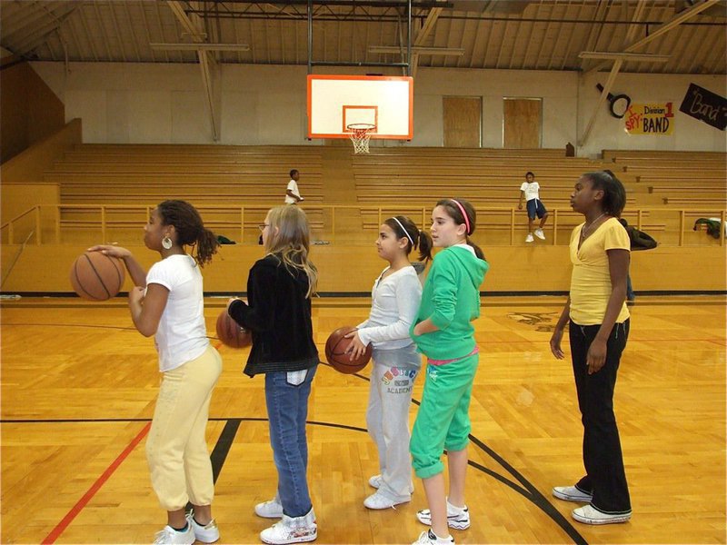 Image: All on the line — Raven Harper, Jennifer McDaniel, Ashlyn Jacinto, Cassity Childers and Janae Robertson practice free throws.