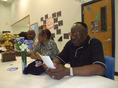 Image: Milford’s fans — Ernest Smith, Gertie Smith and Ernest Smith, Sr. join Milford Bulldogs’ fans in support of the Bulldogs.