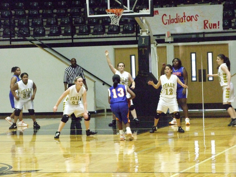 Image: A Gator attacks — The Italy zone defense forces a jump shot from Gateway.