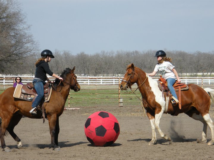Image: Soccer Showdown — Elizabeth Terry, left, and Dakotah Van Huss both of Waxahachie, go head to head to get the soccer ball in a game of equine soccer at the ECEYA meeting at the Flying Dollar Ranch in Italy.