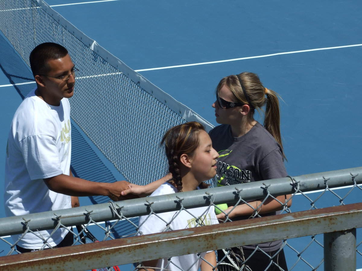 Image: Jacob and Delma — In a show of sportsmanship, Jacob and Delma congratulate the Dawson player after the match.