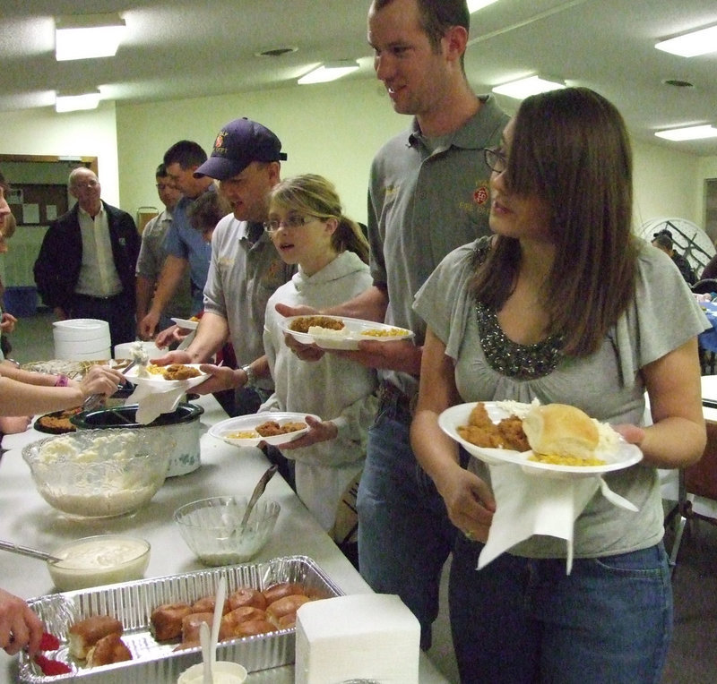 Image: Supper’s ready — Holly and Eric Bradley were happy to lead the buffet line.