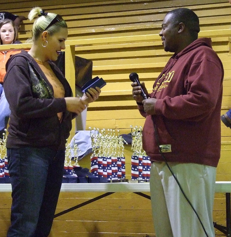 Image: Coaches recognized — Elizabeth Evans accepts her award for her participation in 2009 basketball season.  Each coach received a beautiful etched glass paperweight.