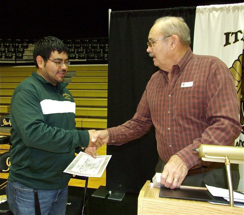 Image: Perez receives honor — Representing the Italy Masonic Lodge #647, Mr. Fred Ivy congratulates IHS band director Jesue Perez and presents him with the Mirabeau Lamar Award for Excellence in Education complete with certificated and medal.