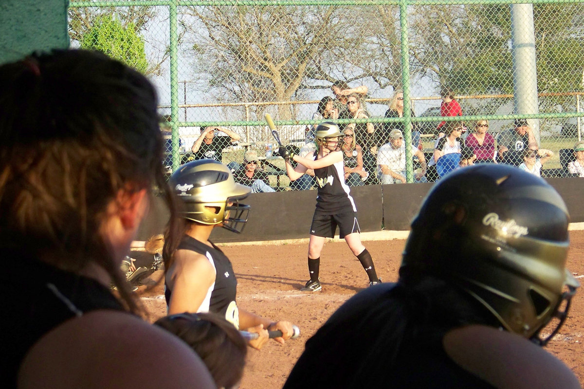 Image: Griffith goes for it — Abby Griffith’s teammates watch her bat from the Italy dugout. The Lady Gladiators began District against Covington tomorrow night.