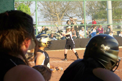 Image: Griffith goes for it — Abby Griffith’s teammates watch her bat from the Italy dugout. The Lady Gladiators began District against Covington tomorrow night.
