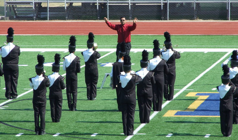 Image: Mr. Perez leads the pre-performance warm-ups