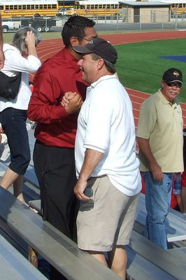 Image: Congratulations! — Eubank congratulates Mr. Perez with fellow School Board member, Tommy Morrison and School Board president, Cheryl Owen look on.  Earlier in the day Mr. Perez mentioned how much he appreciated the support from the parents.  He noted that this year marks a first year for such a large number of hometown spectators.  It is estimated that there were approximately 20 Italians there.