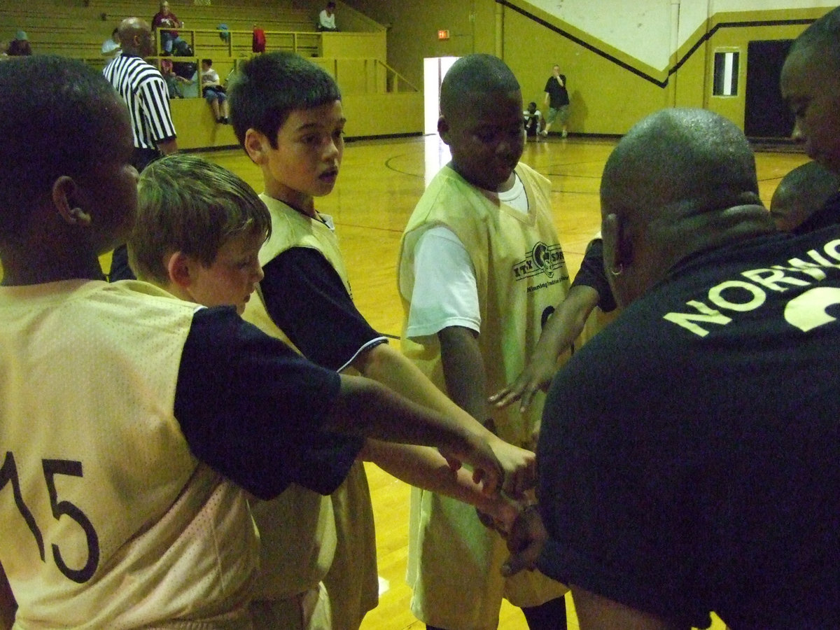 Image: Norwood calls huddle — Coach Ken Norwood gets his team to focus on closing out the game.