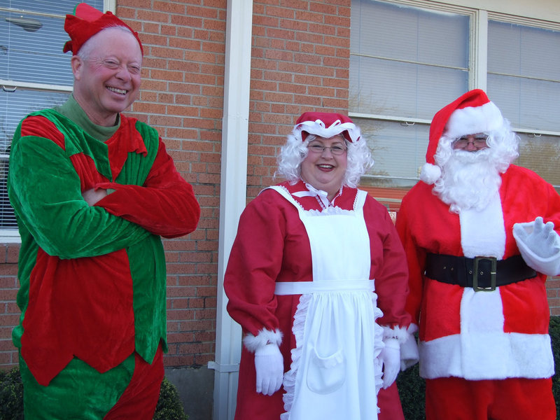 Image: Have you been good? — Santa, Mrs. Claus and the head elf are checking the list, not once but twice.  Have you been good this year?