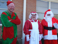 Image: Have you been good? — Santa, Mrs. Claus and the head elf are checking the list, not once but twice. Have you been good this year?