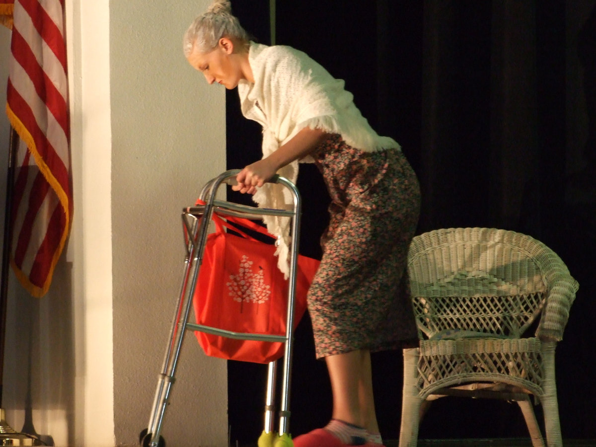 Image: Madge — Madge (Laura Harvey) has had enough of the broken television and is going to try and fix it herself.