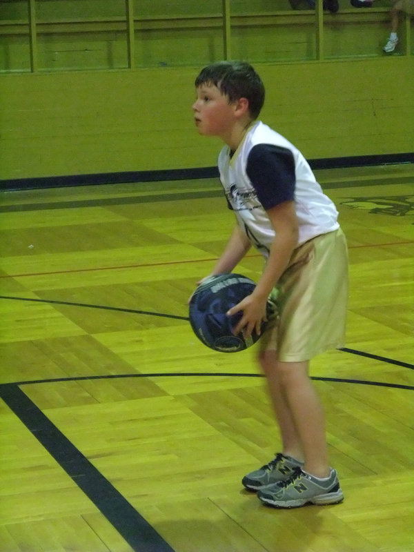 Image: Thomas takes a shot — Thomas practices free shots before the game.