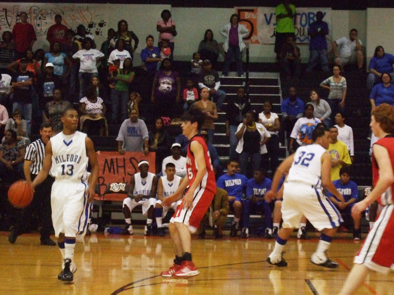 Image: Passing lane — Milford’s looks for a lane inside in order to drive past Midway for the Area Championship.