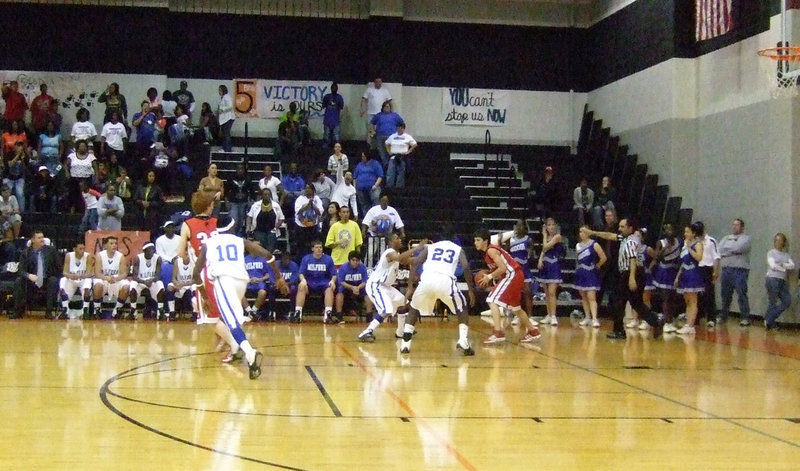 Image: All bark, and all bite! — Milford is unwilling to meet Midway at the halfcourt point. Instead, Milford utilizes their full court press to ground the Falcons.