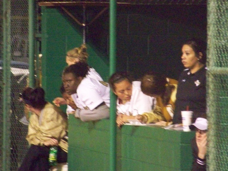 Image: Stats — Coaches Reeves and Richards study the Lady Gladiator defense while Paige Westbrook (7th grade manager) works hard keeping stats.