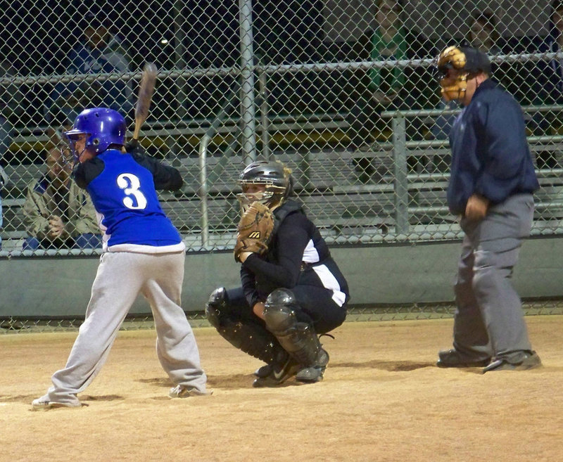 Image: Signs — Julia McDaniel gives the pitch signal to Megan Richards.