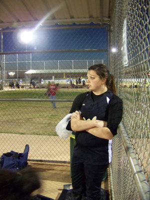 Image: Game face on ice — Cori Jeffords nurses a sore arm between innings with ice.