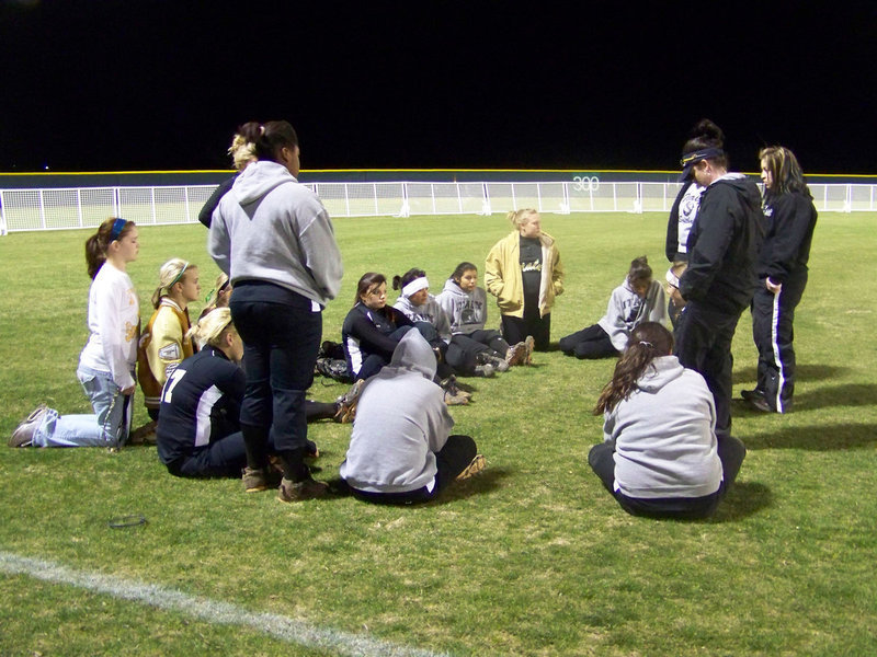 Image: Post Game — Coaches and players discuss the game.