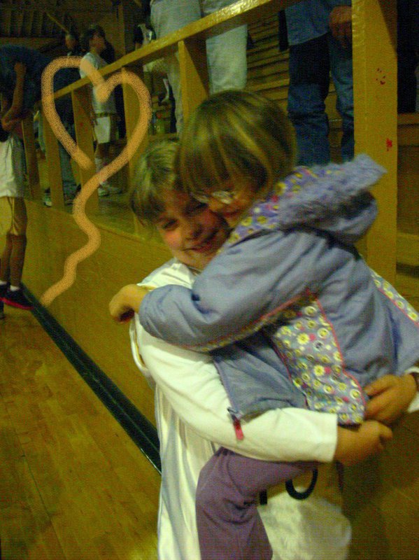 Image: Hugs all ‘round — Italy players get congratulatory hugs from their admiring fans after blowing out the candles on Hillsboro Light Pink’s victory wish. Italy won the game 23-15.