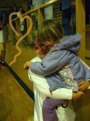 Image: Hugs all ‘round — Italy players get congratulatory hugs from their admiring fans after blowing out the candles on Hillsboro Light Pink’s victory wish. Italy won the game 23-15.